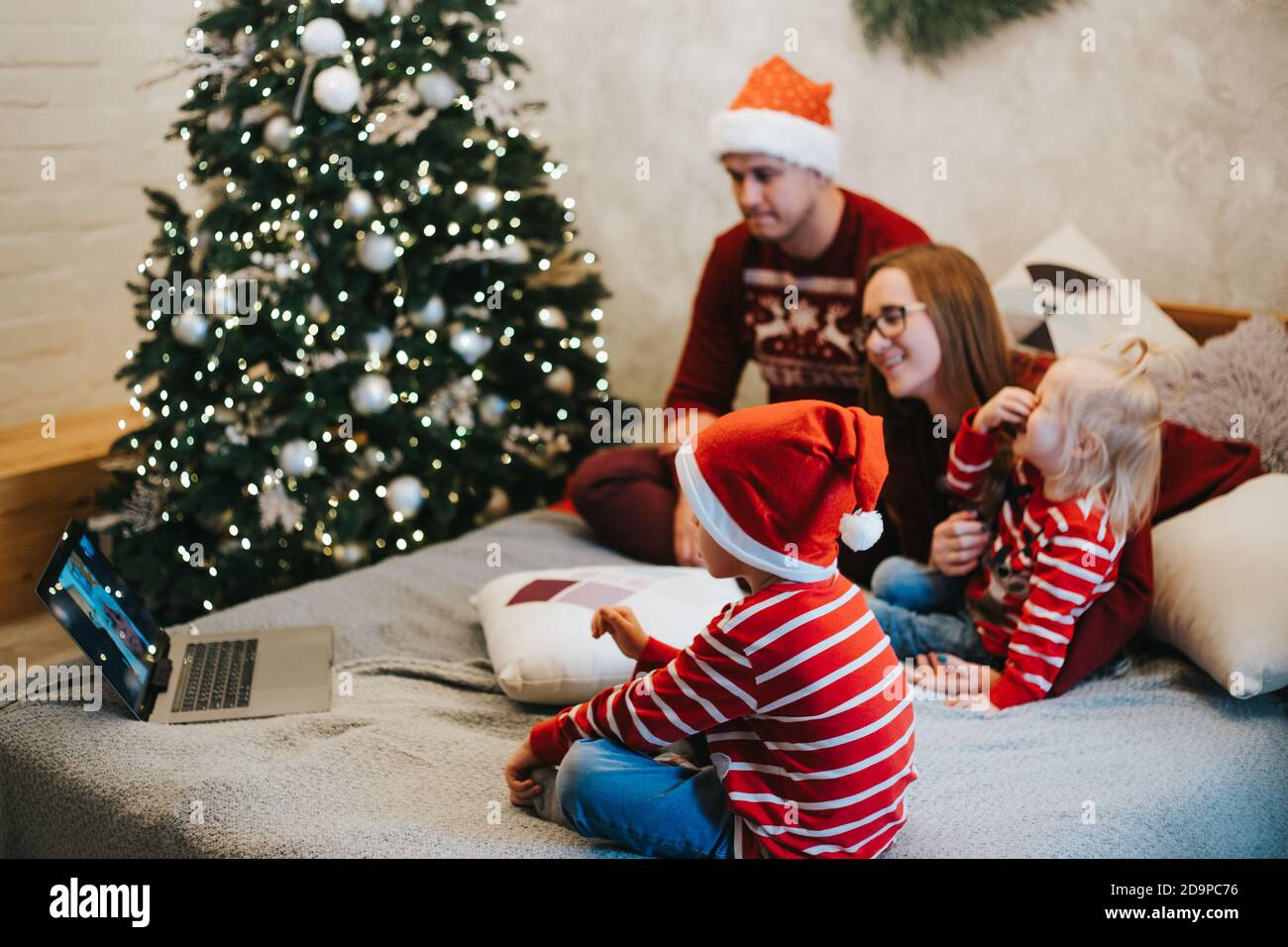 Cheerful children talking to Santa Claus on video chat at Christmas Stock Photo