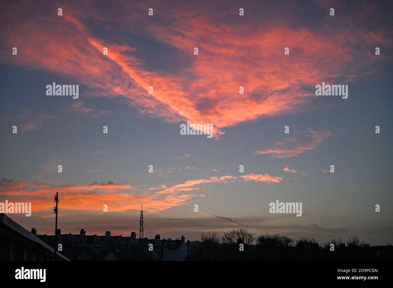 Brighton UK 7th November 2020 - The sun rises over the Whitehawk Hill transmitting station mast in East Brighton this morning . The Whitehawk Transmitting Station is a broadcasting and telecommunications facility  and is the city's main transmission facility for television and radio signals : Credit Simon Dack / Alamy Live News Stock Photo