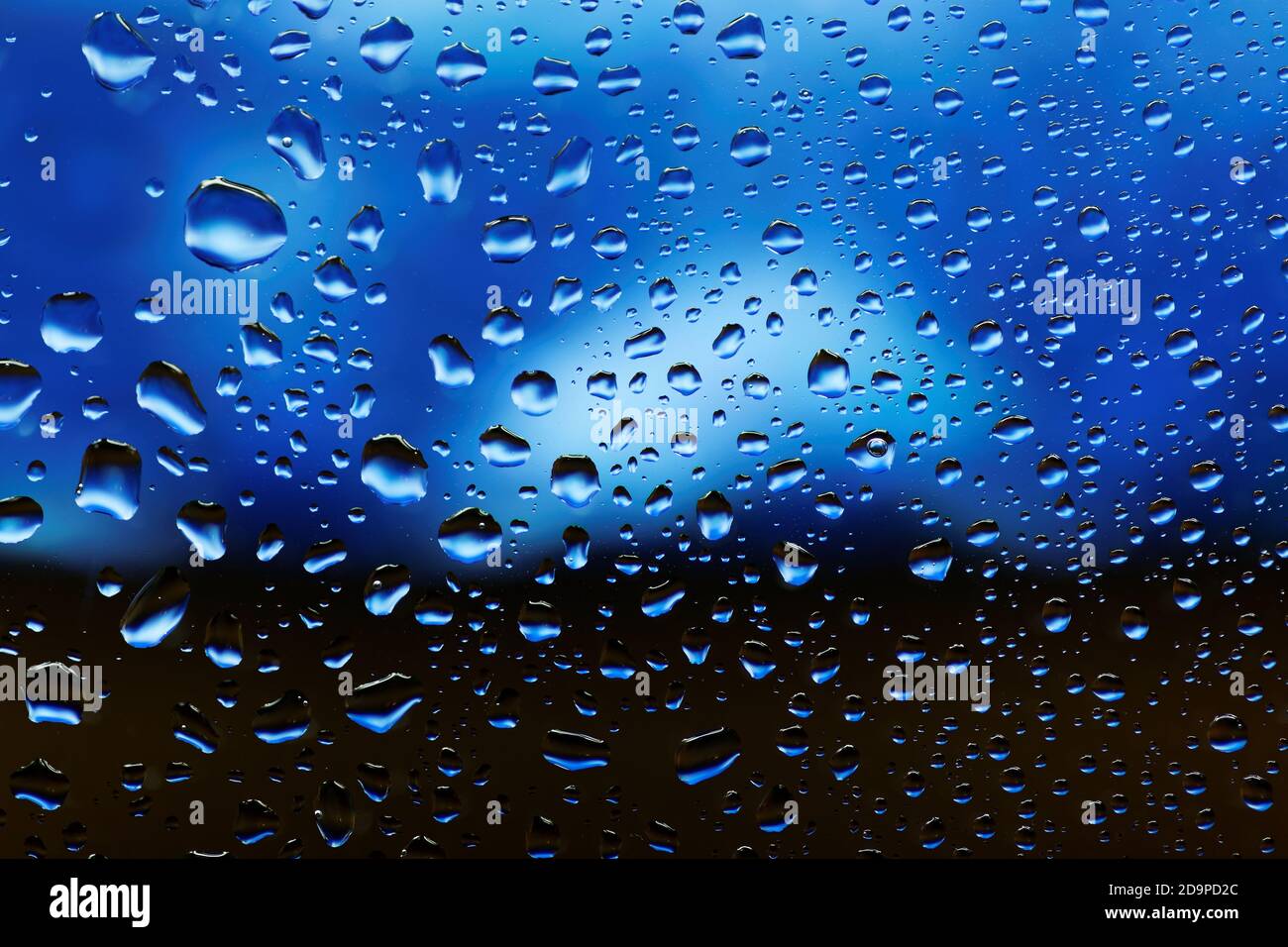 Water drops on the glass over blue background Stock Photo - Alamy