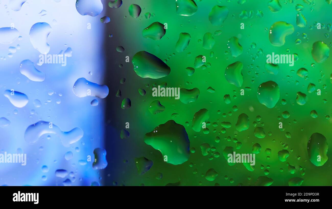 Water drops on the glass over blue and green background Stock Photo - Alamy