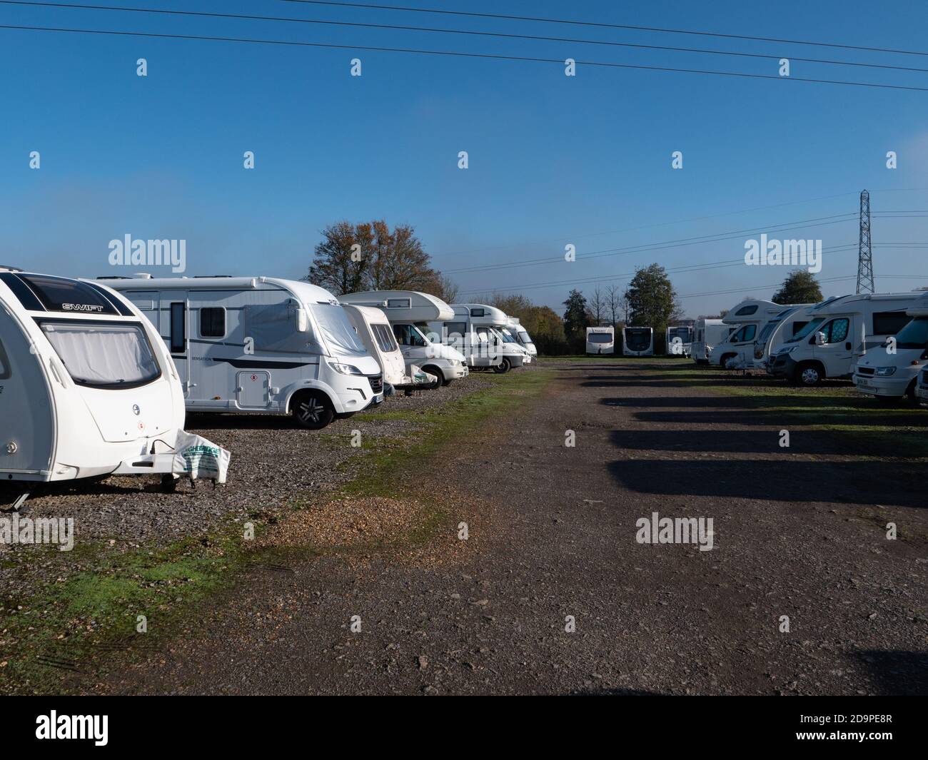A collection of motorhomes and caravans in storage ready for the winter. Near Trowbridge, Wiltshire, England, UK Stock Photo