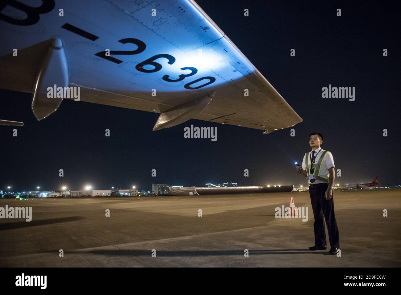 (201107) -- SHENZHEN, Nov. 7, 2020 (Xinhua) -- Wang Qinjin checks the wings of a plane at Bao'an International Airport in Shenzhen, south China's Guangdong Province, Sept. 9, 2020. Wang Qinjin, a young man from Leping of east China's Jiangxi Province, came to Shenzhen to search for a job after graduating from college in July of 2009. Attracted by the talent training program of the SF Express Co., Ltd., Wang applied for the company's warehouse keeper and delivery man, and was soon recruited in. He worked very hard, being selected as a future manager eight months later. Also in the year 2 Stock Photo