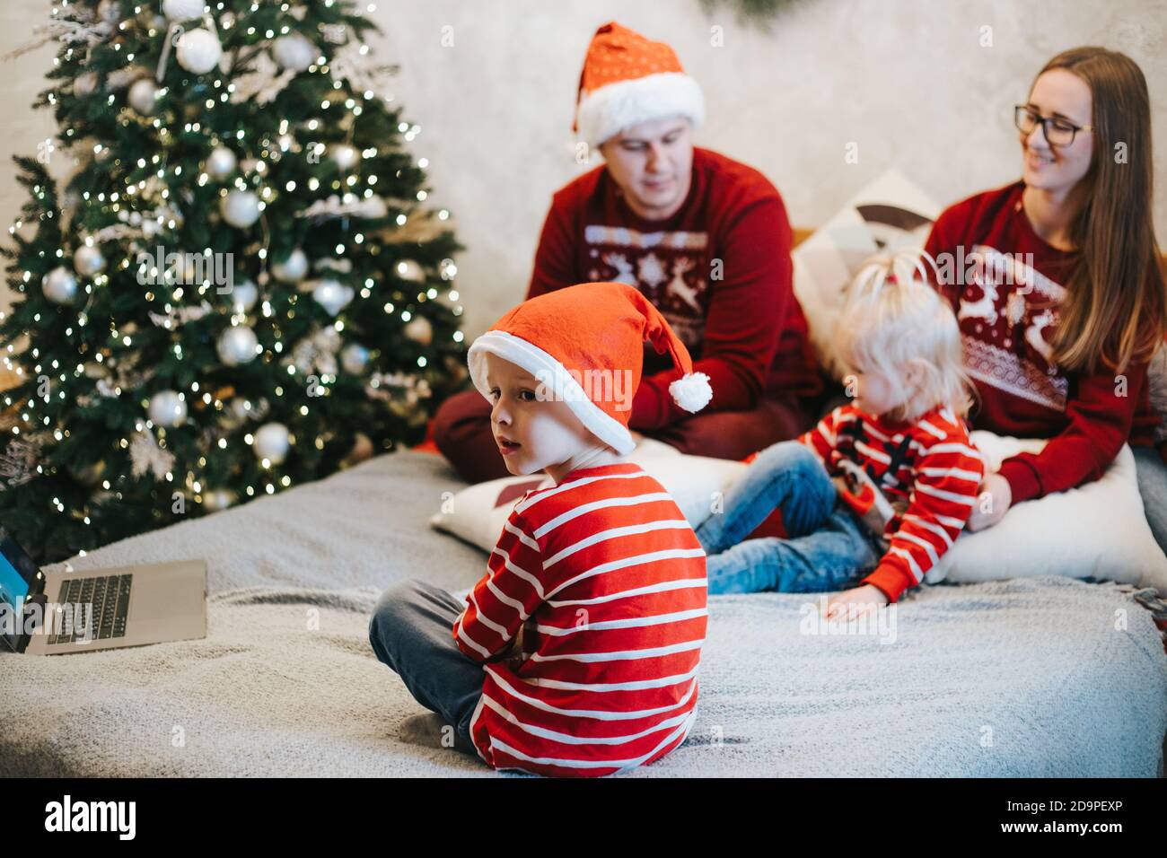 Cheerful children talking to Santa Claus on video chat at Christmas Stock Photo