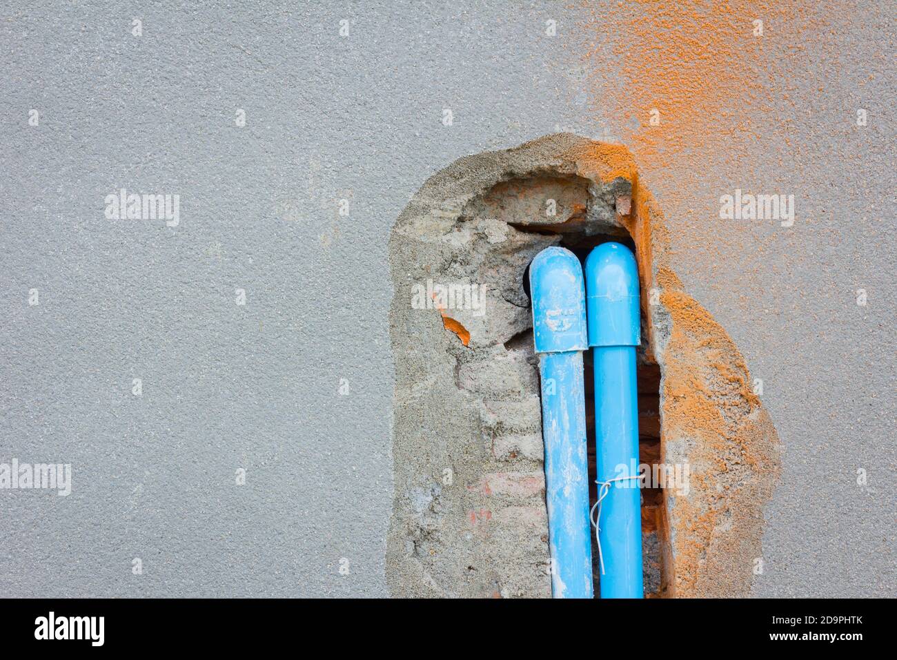 bury a pvc pipe in the concrete wall with copyspace on the left Stock