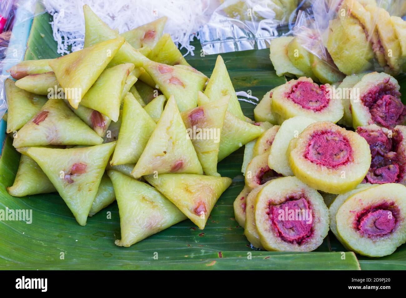 Bananas with sticky rice on green banana leaf on thai market Stock Photo