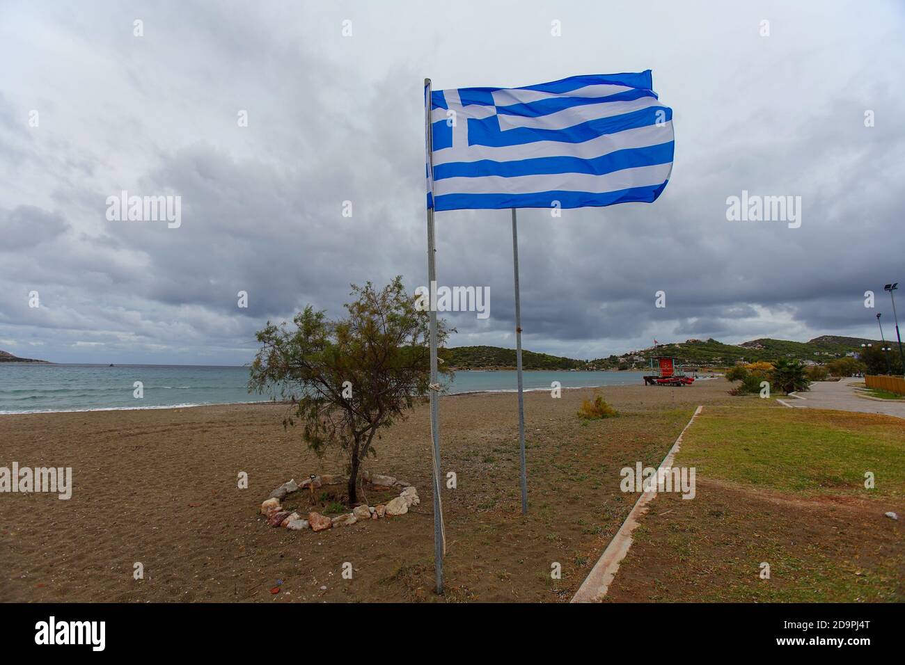 The Greek flag during quarantine aan under the cloudy sky Stock Photo