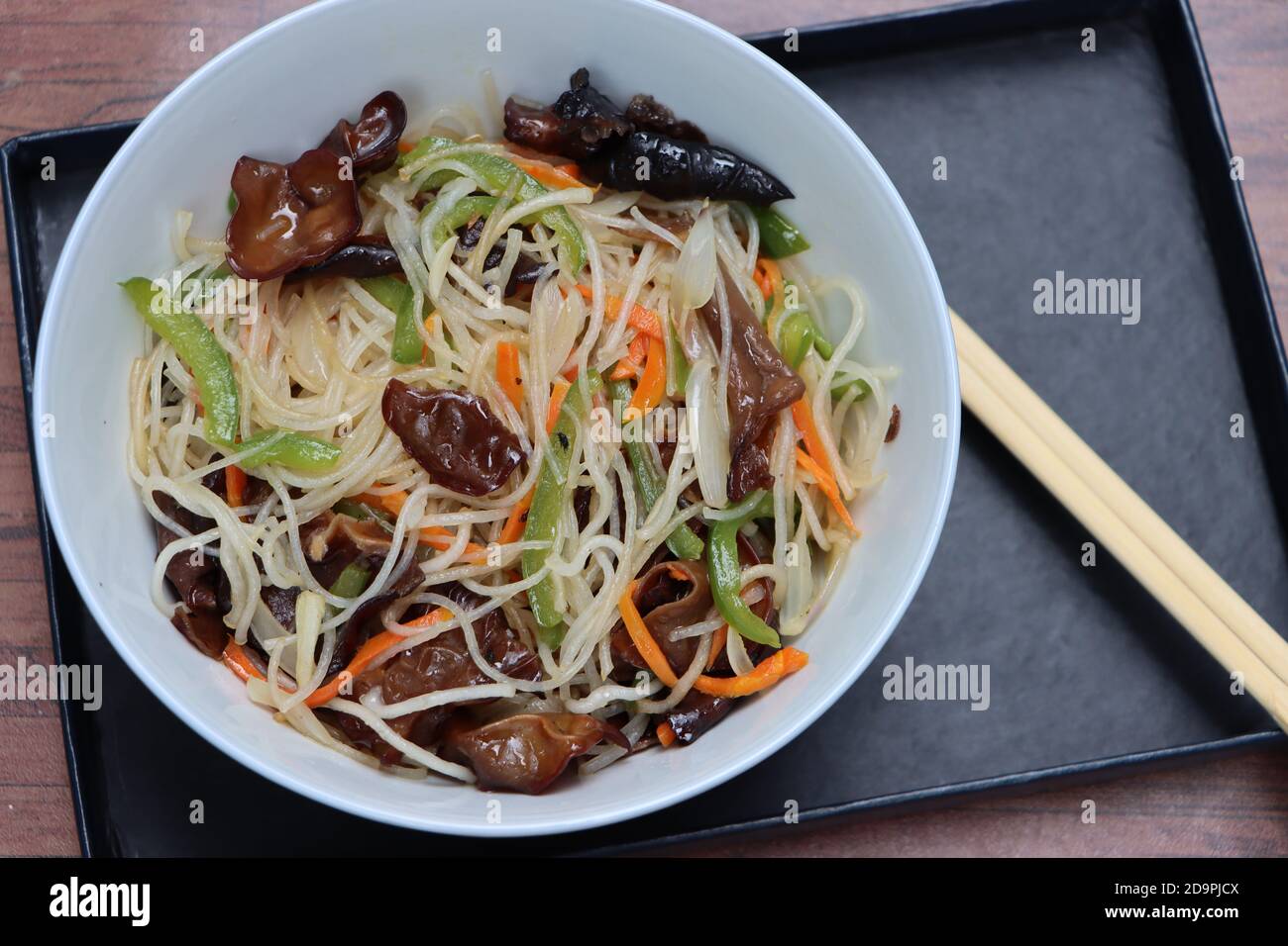 Rice noodles stir fry in bowl with ear wood mushrooms, vermicelli salad
