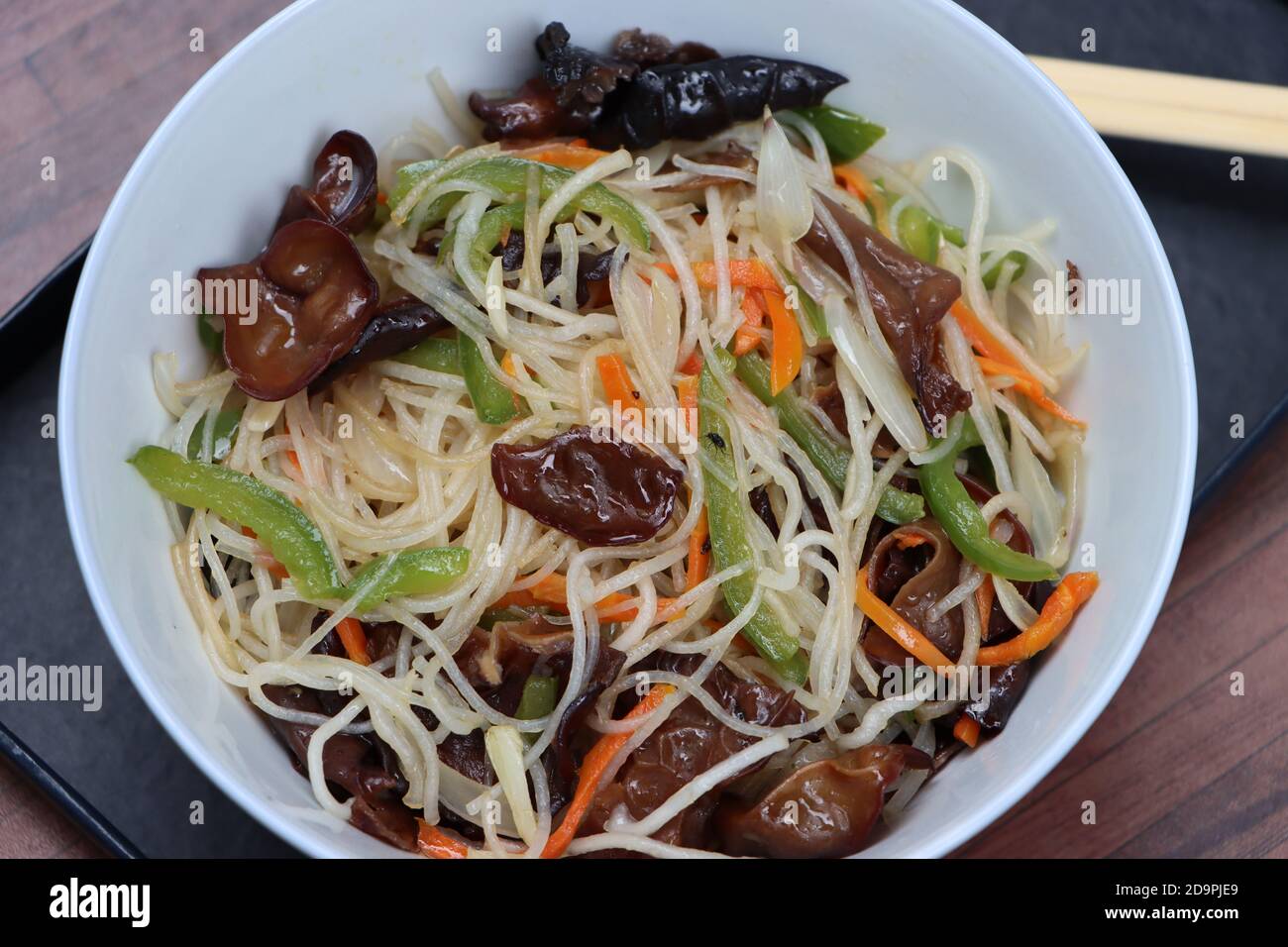 Rice noodles stir fry in bowl with ear wood mushrooms, vermicelli salad