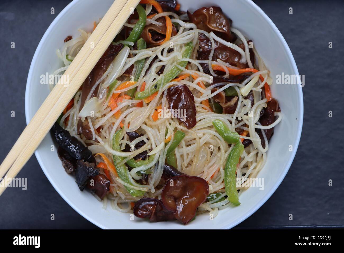 Rice noodles stir fry in bowl with ear wood mushrooms, vermicelli salad