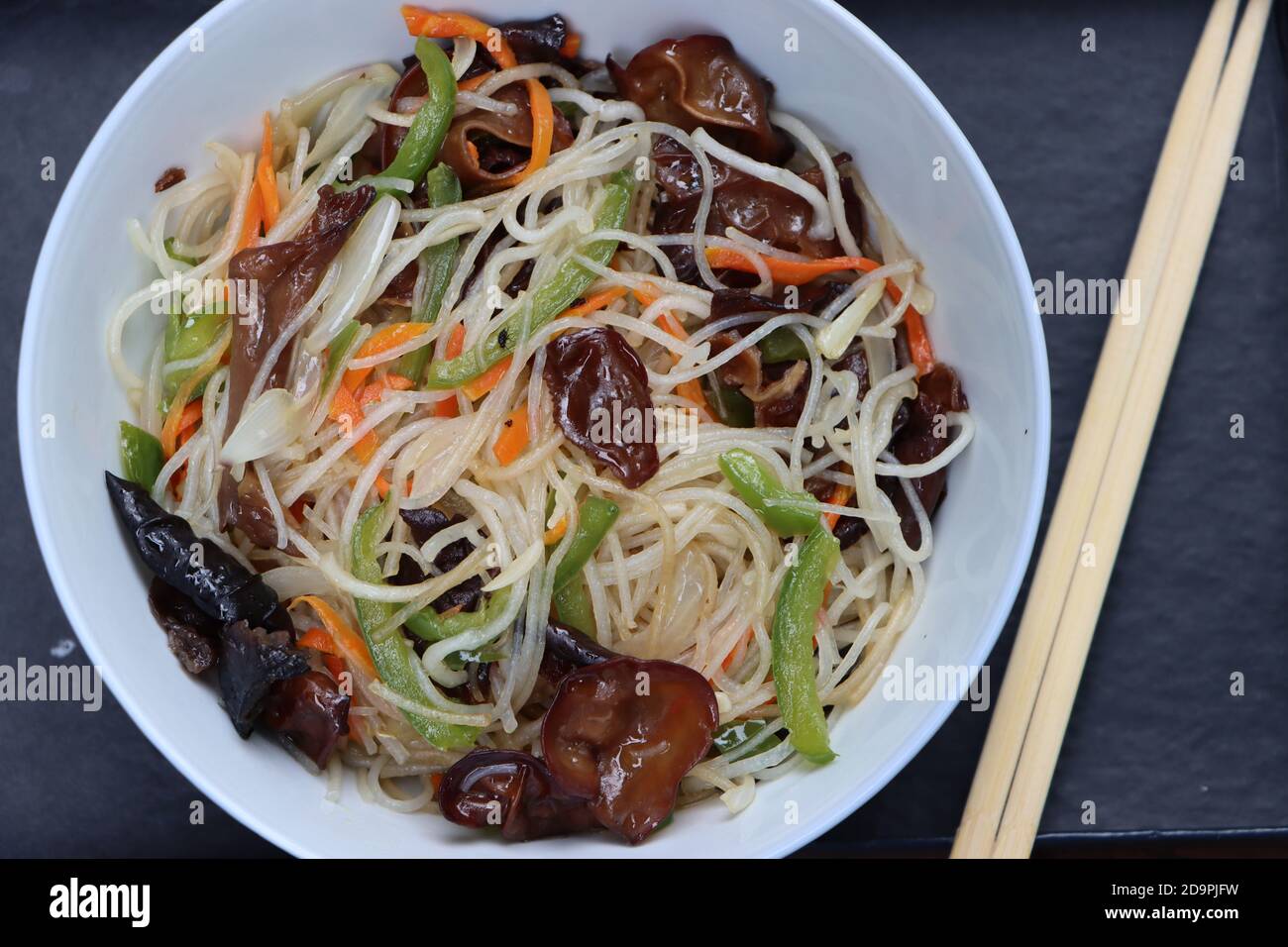 Rice noodles stir fry in bowl with ear wood mushrooms, vermicelli salad