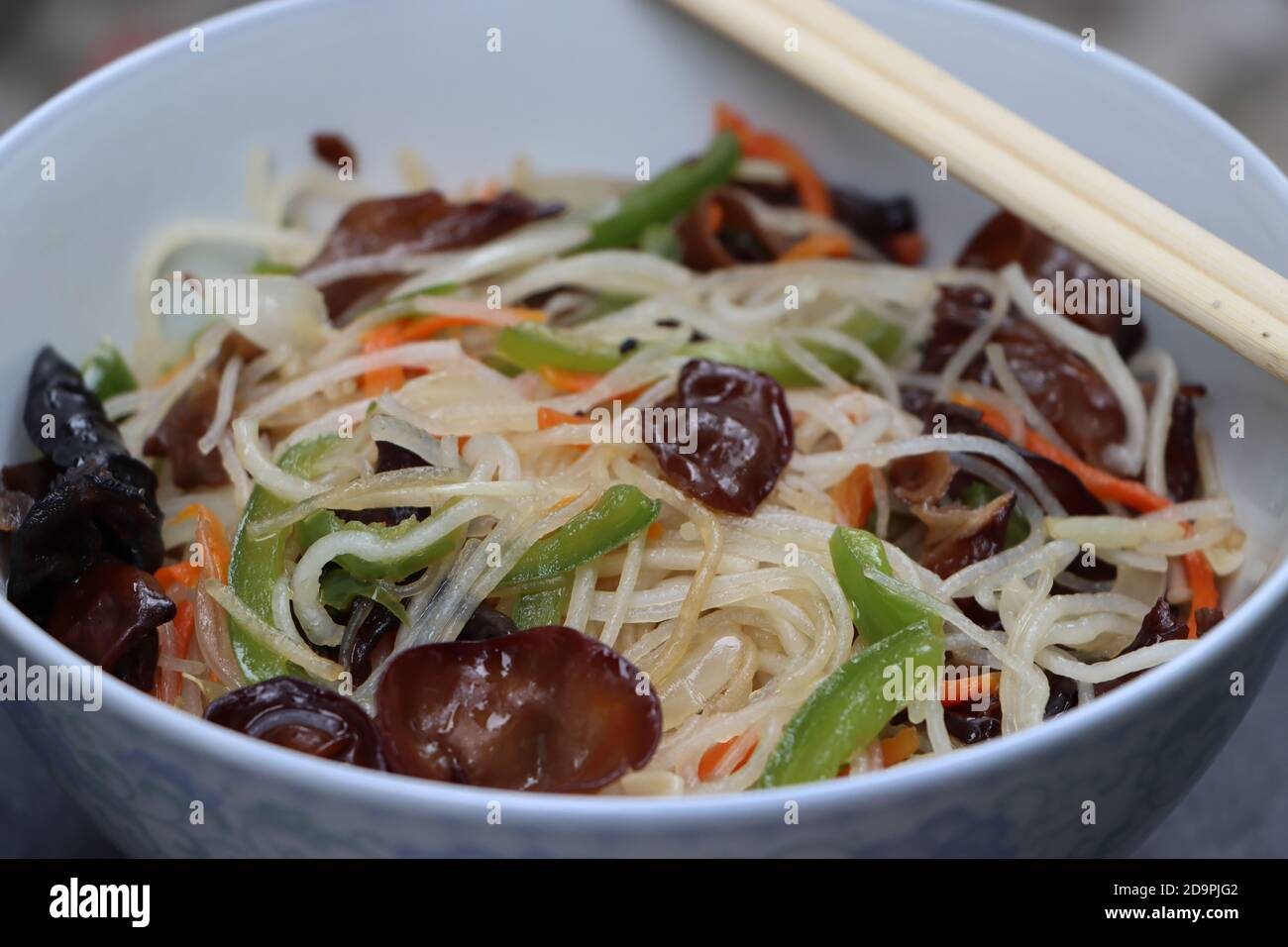 Rice noodles stir fry in bowl with ear wood mushrooms, vermicelli salad