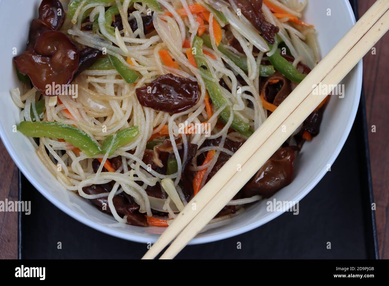 Rice noodles stir fry in bowl with ear wood mushrooms, vermicelli salad