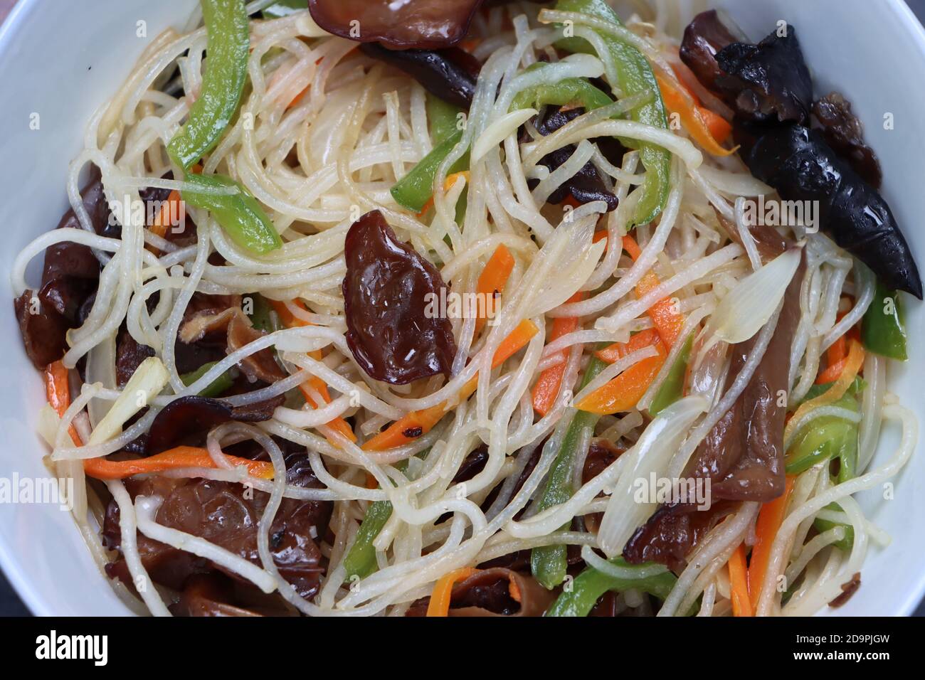 Rice noodles stir fry in bowl with ear wood mushrooms, vermicelli salad