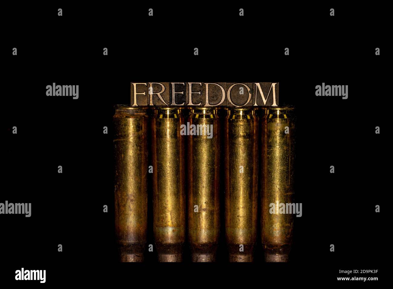 Freedom text message on 50 cal bullet casings against black background Stock Photo