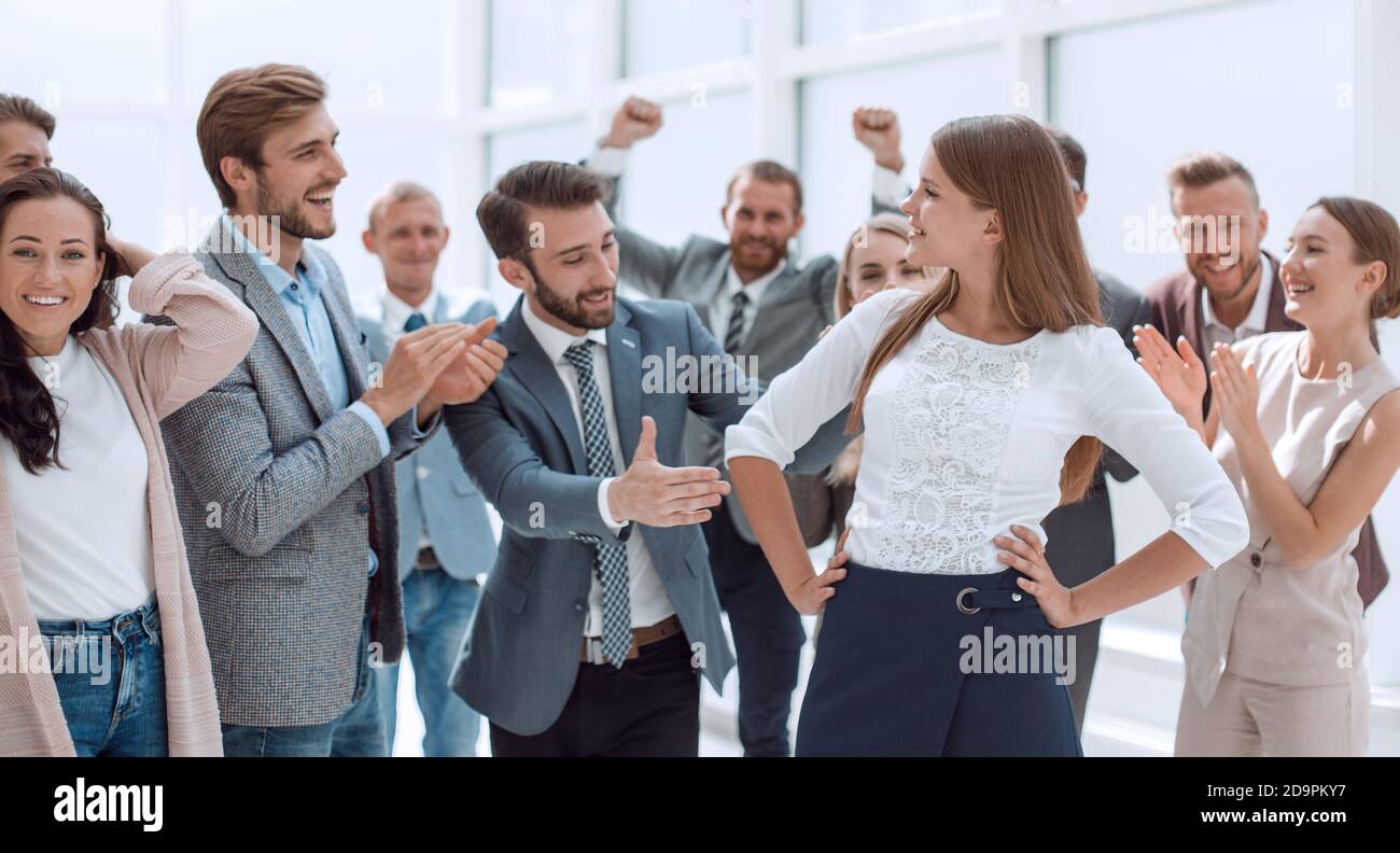 creative business team congratulating their young colleague Stock Photo ...