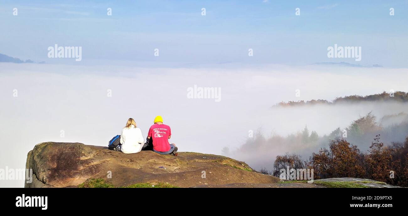 Walkers enjoying the view on top of Black Rocks, Wirksworth, Derbyshire UK Stock Photo