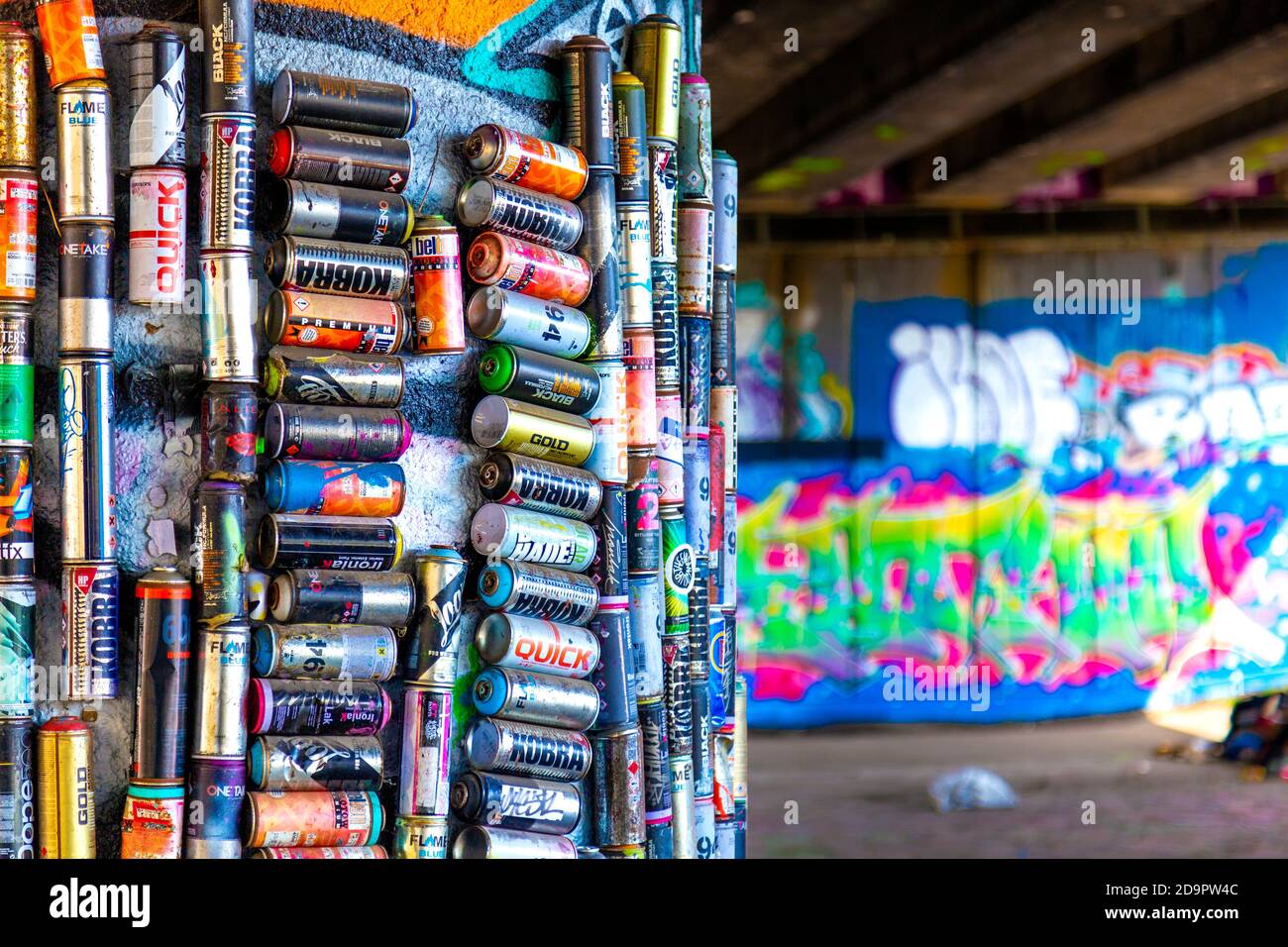 A pillar decorated with empty beer cans under an overpass of the East Cross Route in Stratford, Hackney Cut, London, UK Stock Photo