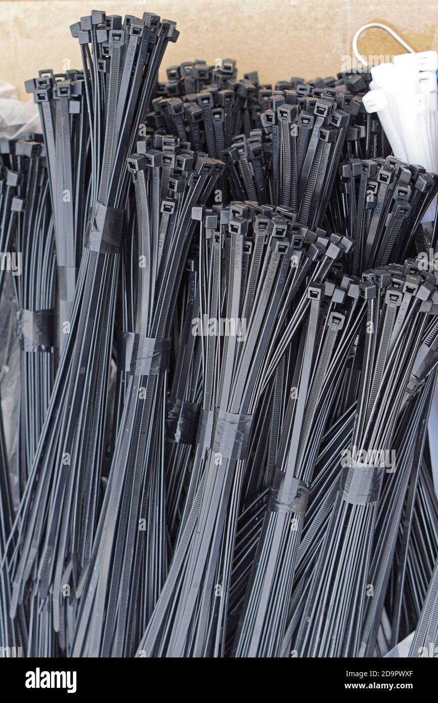 Bundles of new black plastic cable ties Stock Photo Alamy