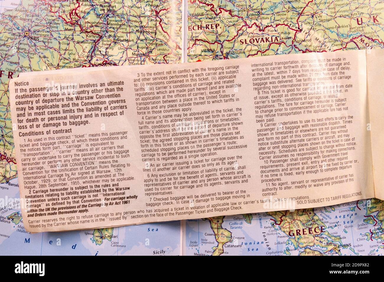 Inside page showing the Warsaw Convention information of a plane ticket from 1989 (for flights between the UK and Canada) on a map of Europe. Stock Photo