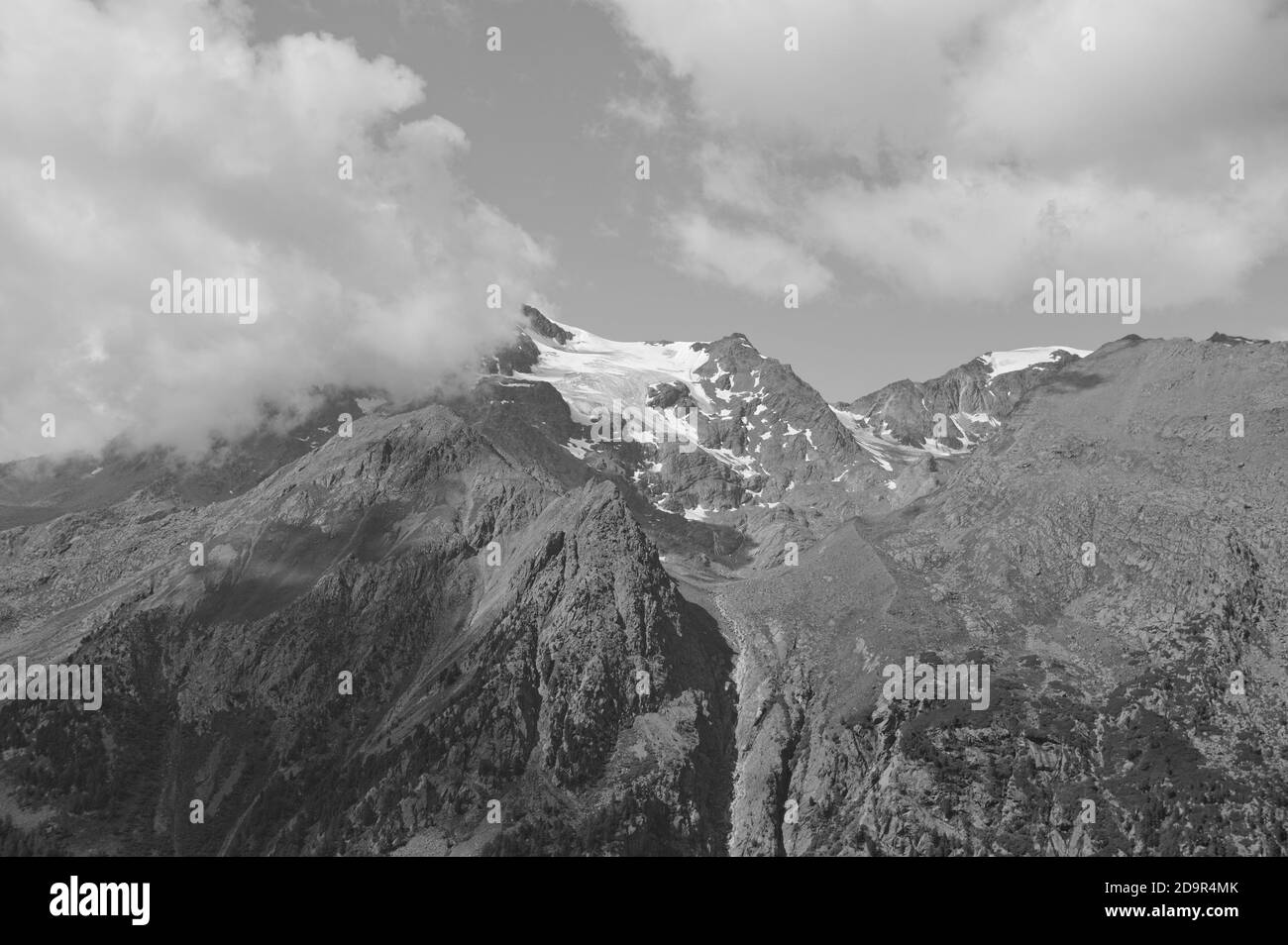 A snowy peak covered by clouds in the Italian Alps (Trentino, Italy, Europe) Stock Photo