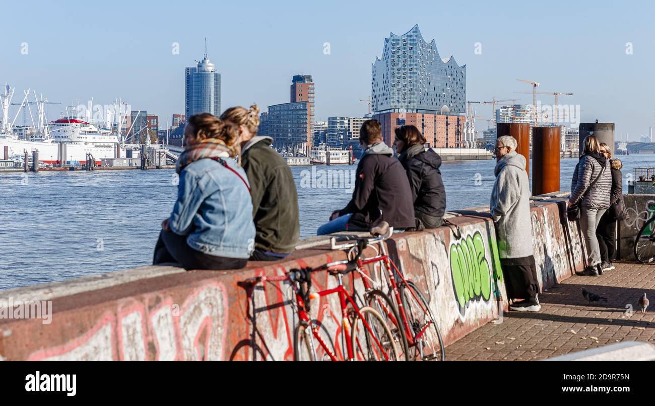 Hamburg, Germany. 07th Nov, 2020. Visitors to the 'Alter Elbtunnel' viewing point enjoy the view from the south over the Elbe to HafenCity with the Elbe Philharmonic Hall in mild autumn weather with an air temperature of 13 degrees Celsius and sunshine. Credit: Markus Scholz/dpa/Alamy Live News Stock Photo