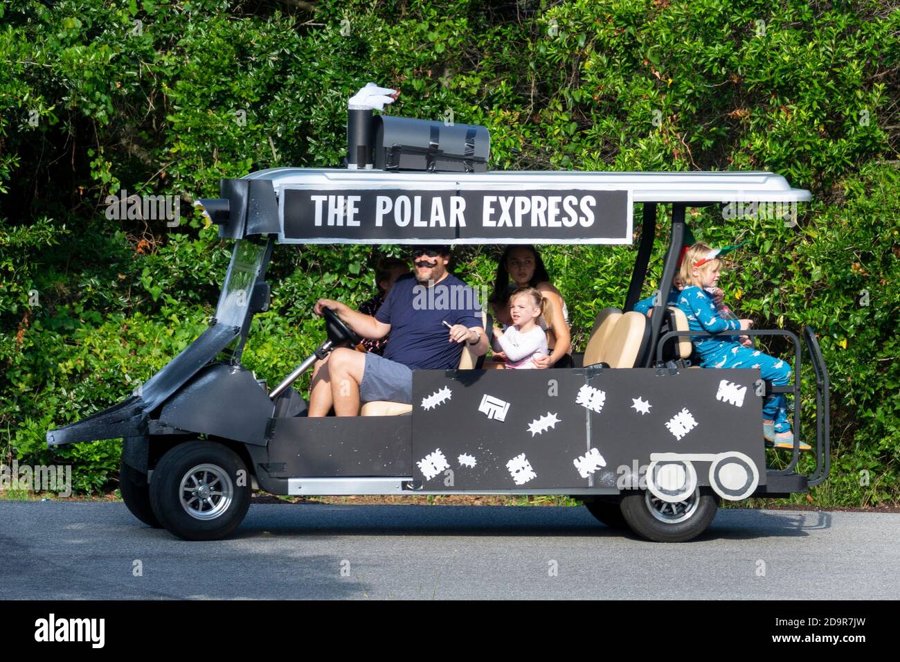 A golf cart float decorated as a the Polar Express rides down the road during the annual Independence Day parade July 4, 2019 in Sullivan's Island, South Carolina. The tiny affluent Sea Island beach community across from Charleston holds an outsized golf cart parade featuring more than 75 decorated carts. Stock Photo