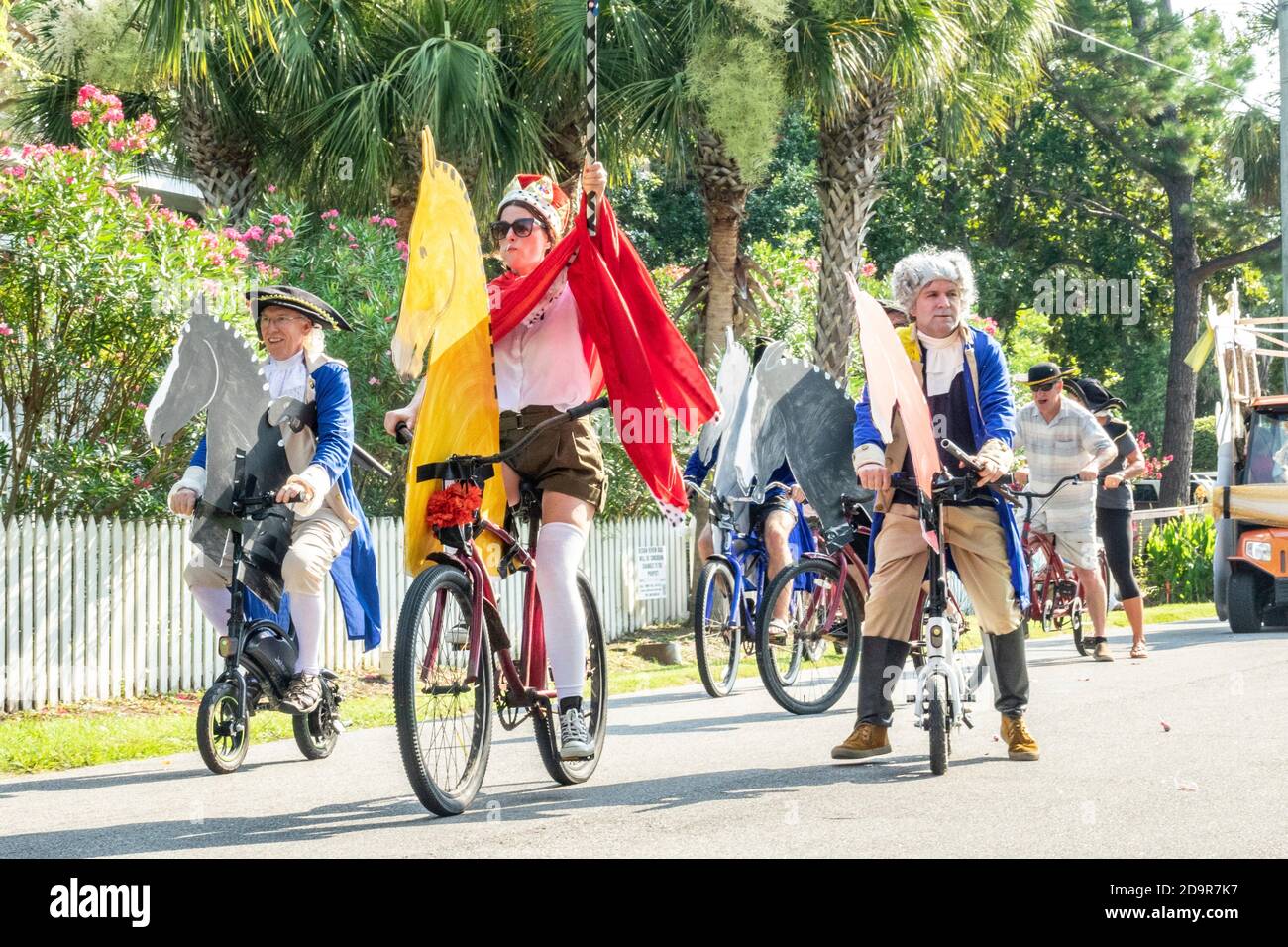 Dressed in costumes bicyclists ride down the road during the annual Independence Day parade July 4, 2019 in Sullivan's Island, South Carolina. The tiny affluent Sea Island beach community across from Charleston holds an outsized golf cart parade featuring more than 75 decorated carts. Stock Photo