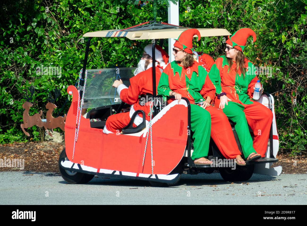 Santa and his elves ride a golf cart decorated as a sled during the  annual Independence Day parade July 4, 2019 in Sullivan's Island, South Carolina. The tank was a tongue-in-check reference to the controversy over the military parade in Washington. Stock Photo