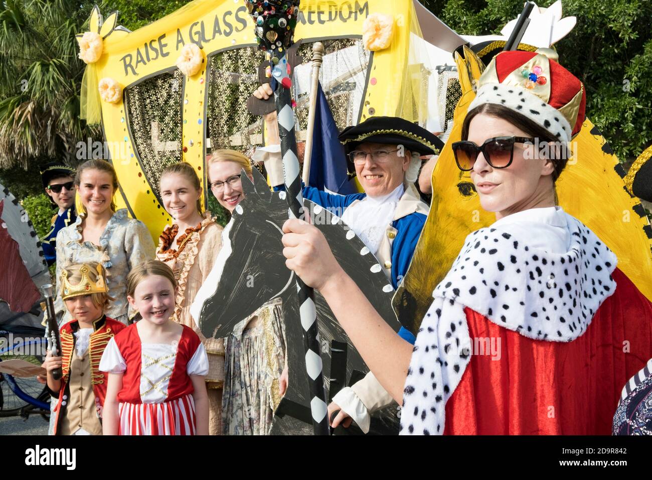 Residents in colonial costumes celebrate the play Hamilton during the annual Independence Day parade July 4, 2019 in Sullivan's Island, South Carolina. The tiny affluent Sea Island beach community across from Charleston holds an outsized golf cart parade featuring more than 75 decorated carts. Stock Photo