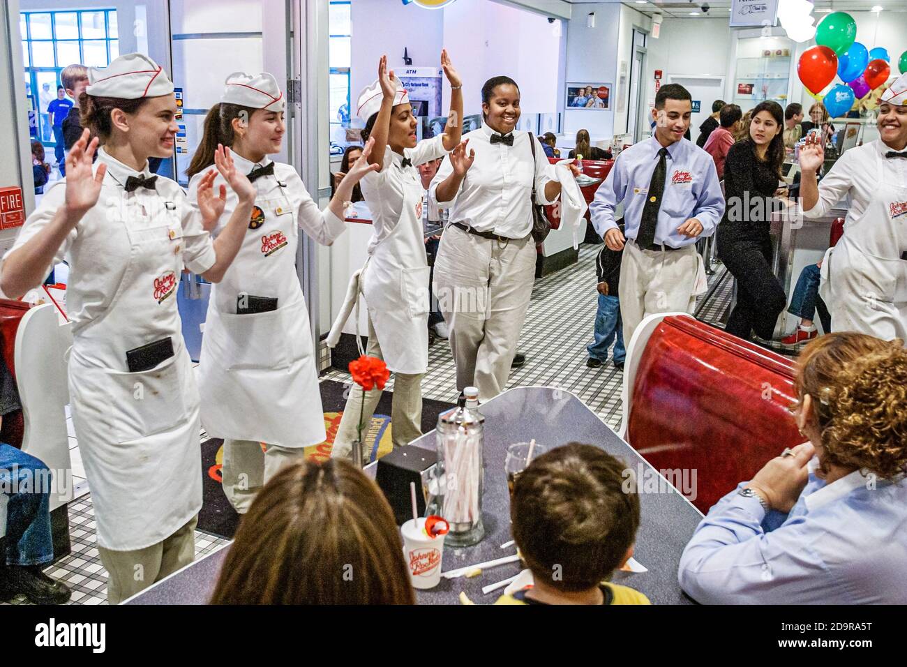 Miami Florida,Aventura Mall Johnny Rockets 1950's diner style,restaurant waiters servers singing happy birthday customers uniforms Stock Photo