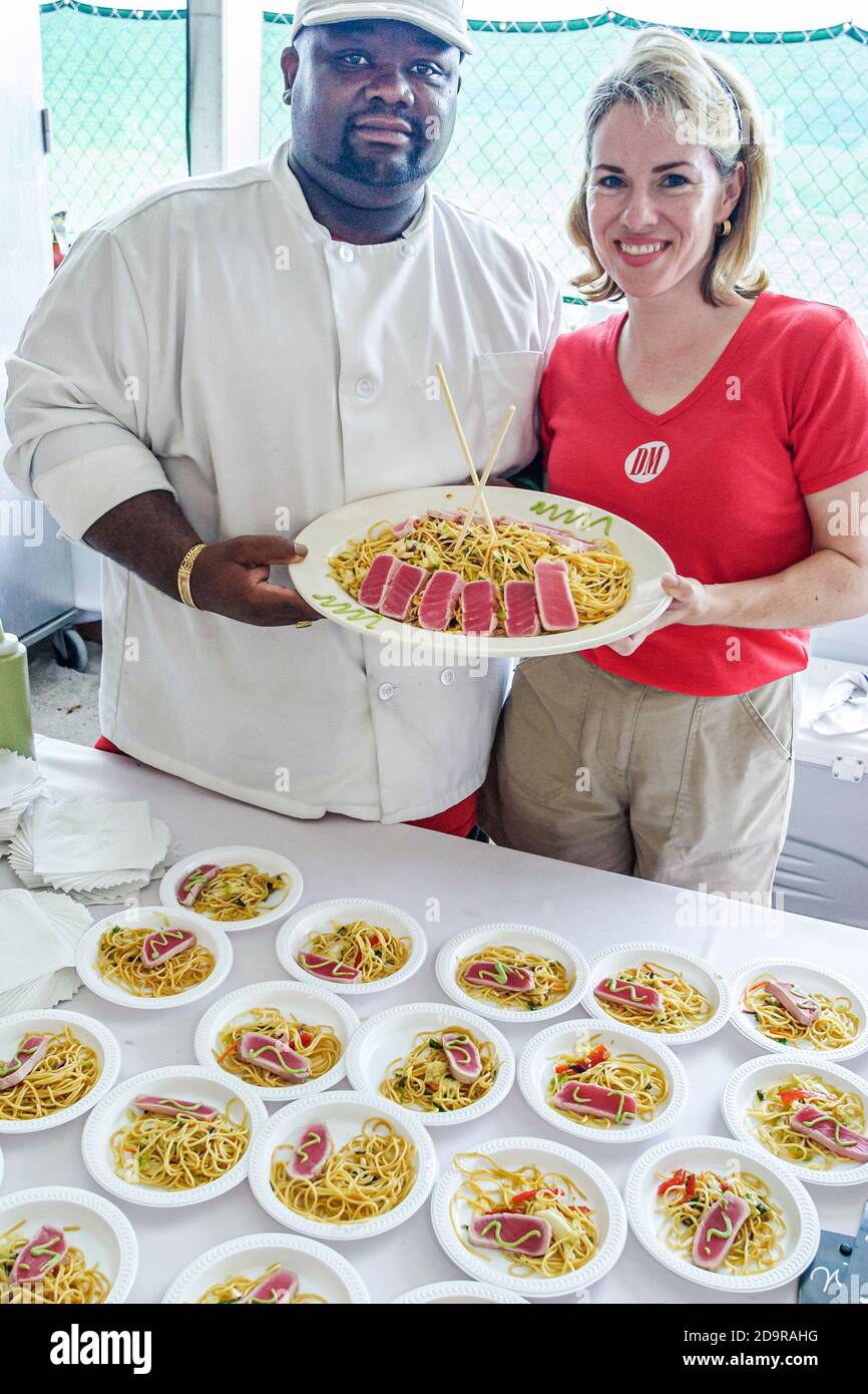 Miami Beach Florida,Wine & Food Festival,annual event tasting sampling celebrity chefs gourmet foods free samples,Black African man chef noodles, Stock Photo