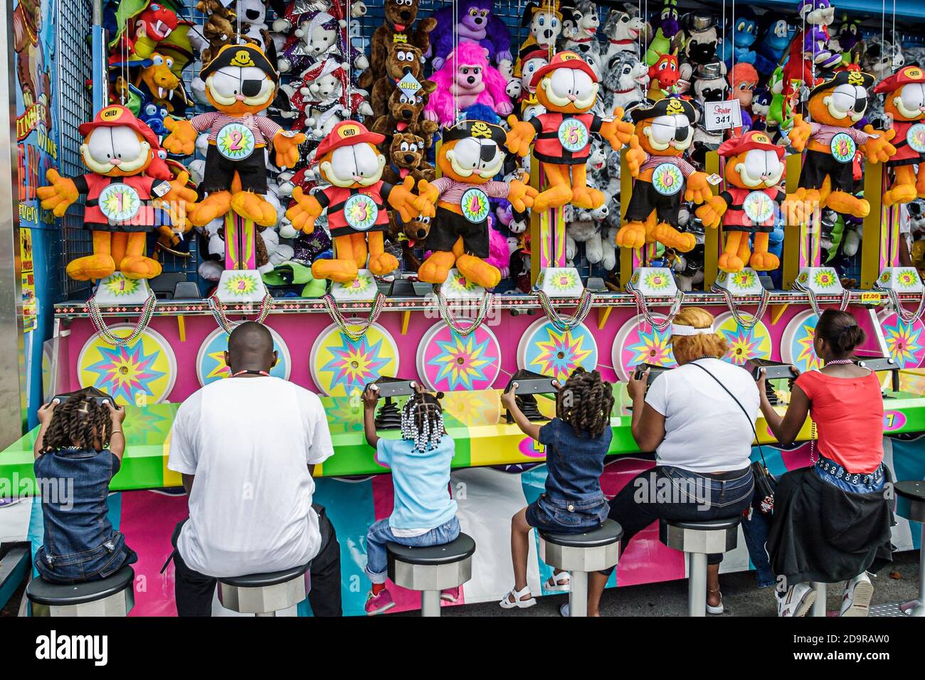 Miami Florida,Dade County Fair & Exposition,annual event carnival midway game prizes stuffed animals,people playing Black African girl girls man, Stock Photo