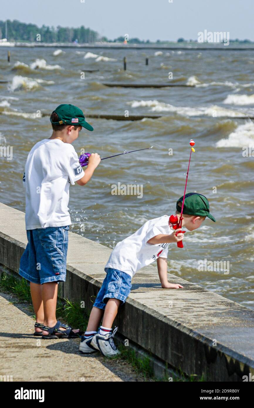 Louisiana Lake Pontchartrain Northshore,Mandeville Lakeshore Drive,child children boy boys brothers siblings fish fishing, Stock Photo
