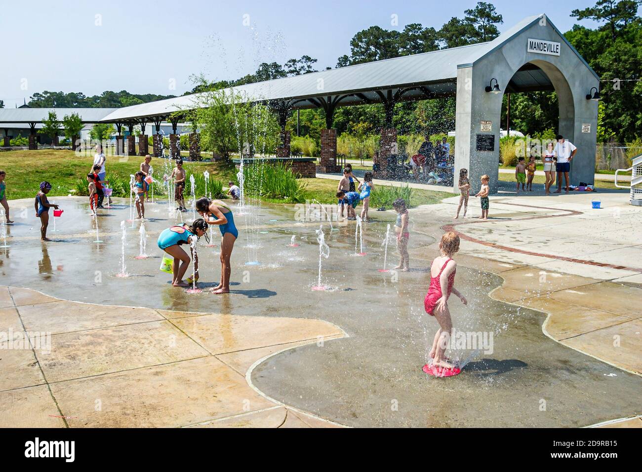 Louisiana Northshore,Mandeville,kids children boys girls play playing interactive ground spray fountain,near Tammany Trace, Stock Photo