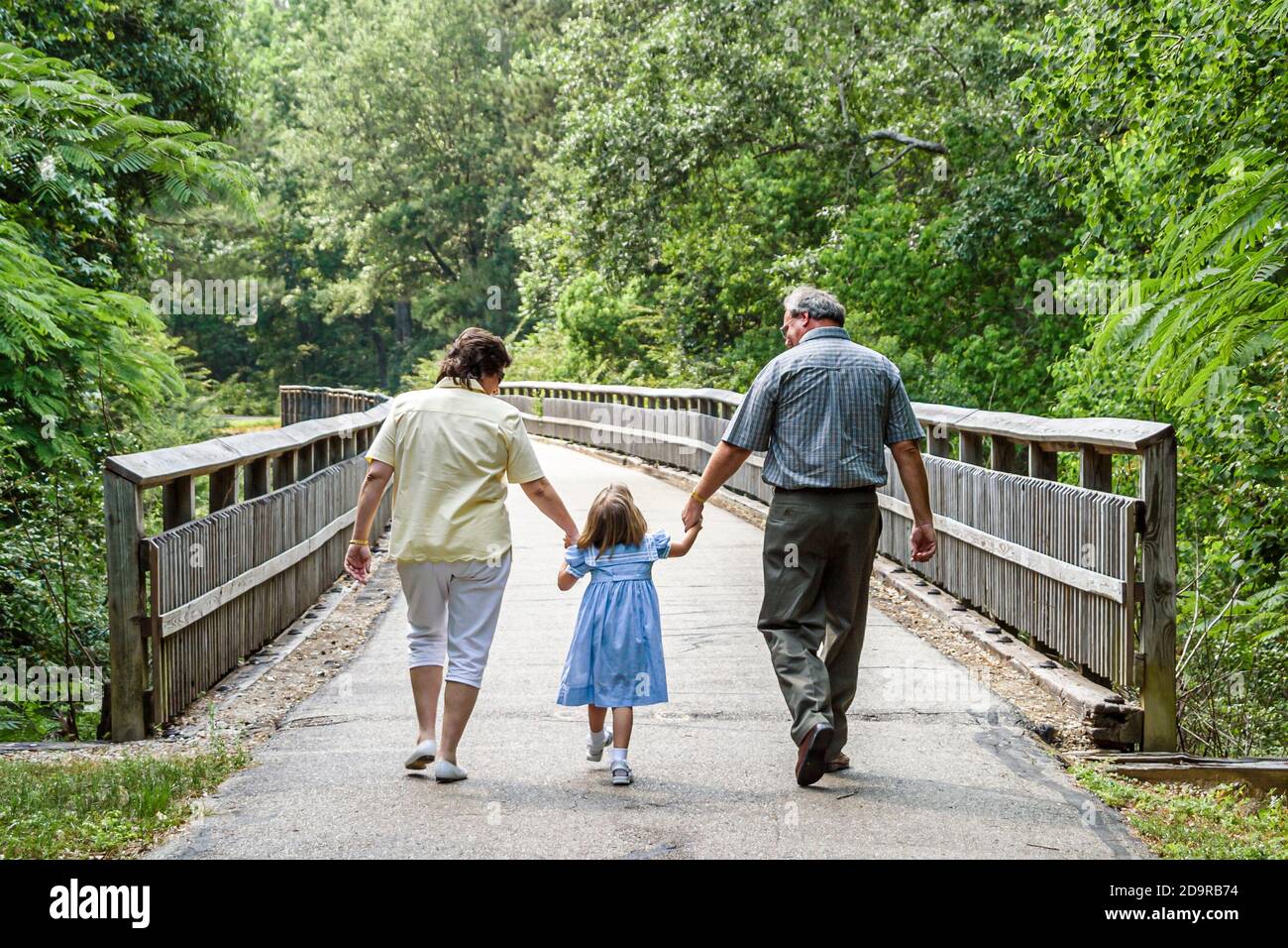 Louisiana Northshore,Abita Springs,Tammany Trace rail trail conversion,family parents child girl daughter mother father walking, Stock Photo