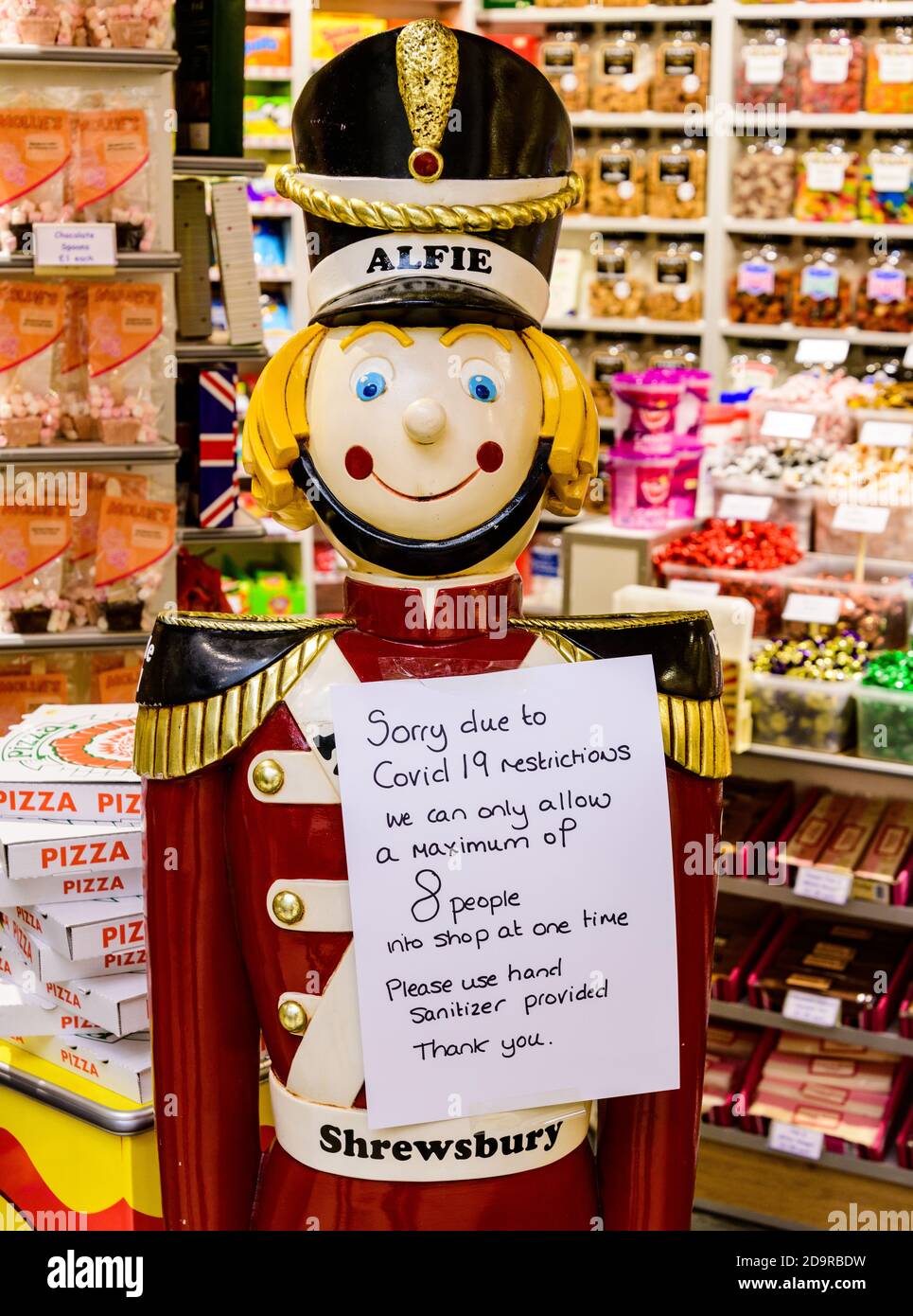 Model life size soldier in Shrewsbury sweetshop holding sign restricting number of people in shop due to covid Stock Photo