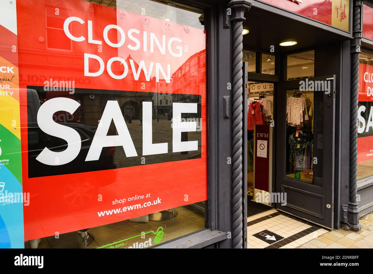 Shop window of Edinburgh Woollen Mills with red Closing Down Sale sign in the High Street of Shrewsbury, Shropshire, West Midlands Stock Photo