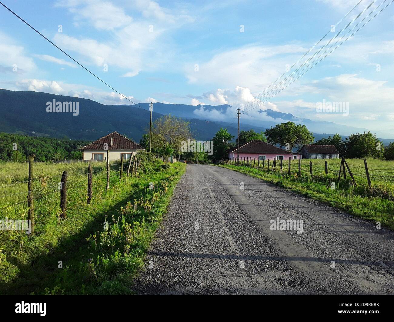 Green mountains, clouds, meadows, village houses and a broken wooden fence. A view from Hendek/Sakarya. Stock Photo