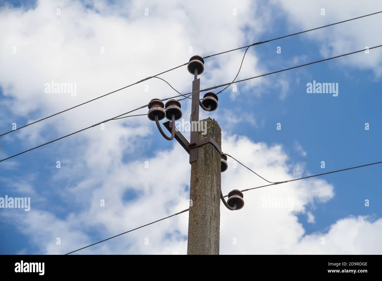 Electric power lines on a blue sky background Stock Photo - Alamy