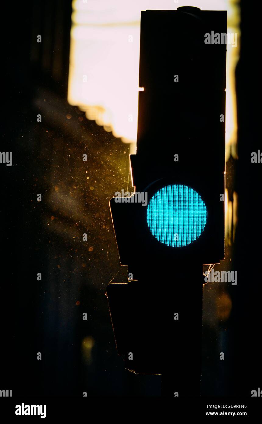 Vertical shot of a traffic light silhouette flashing green Stock Photo Alamy