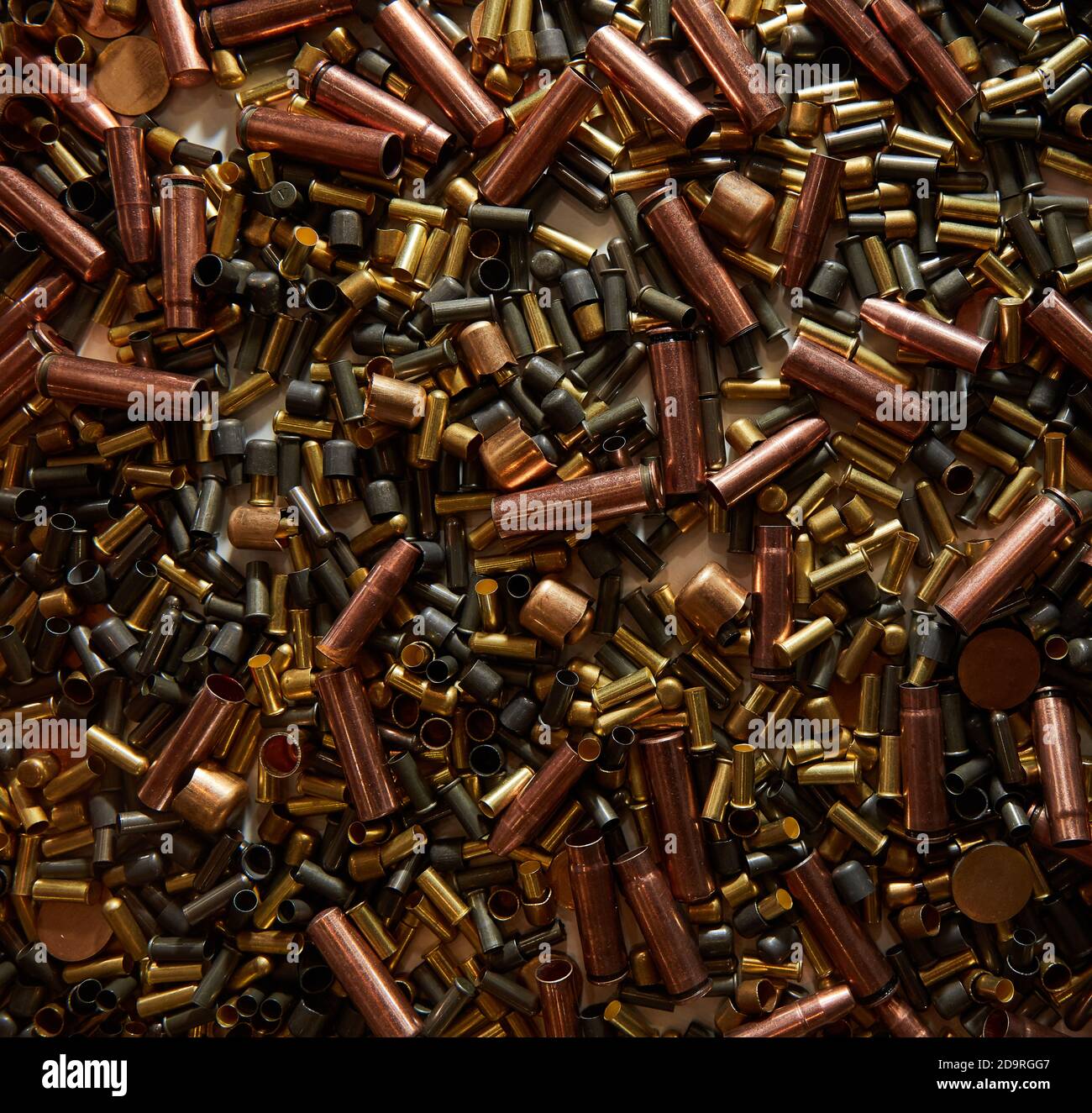 Different size bullet shells on the black ground. War concept