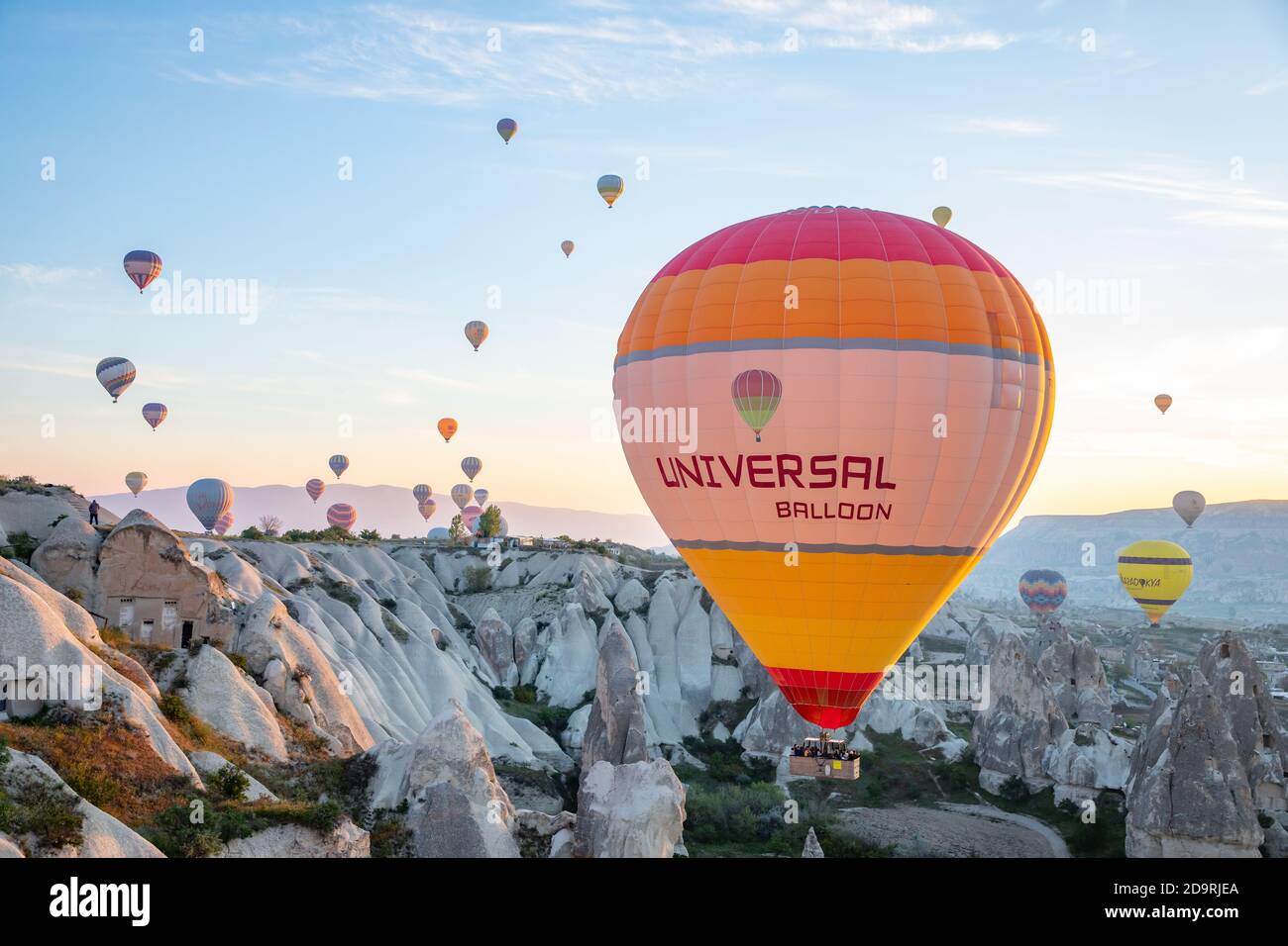 Hot Air balloons flying over Cappadocia valleys on sunrise Stock Photo ...
