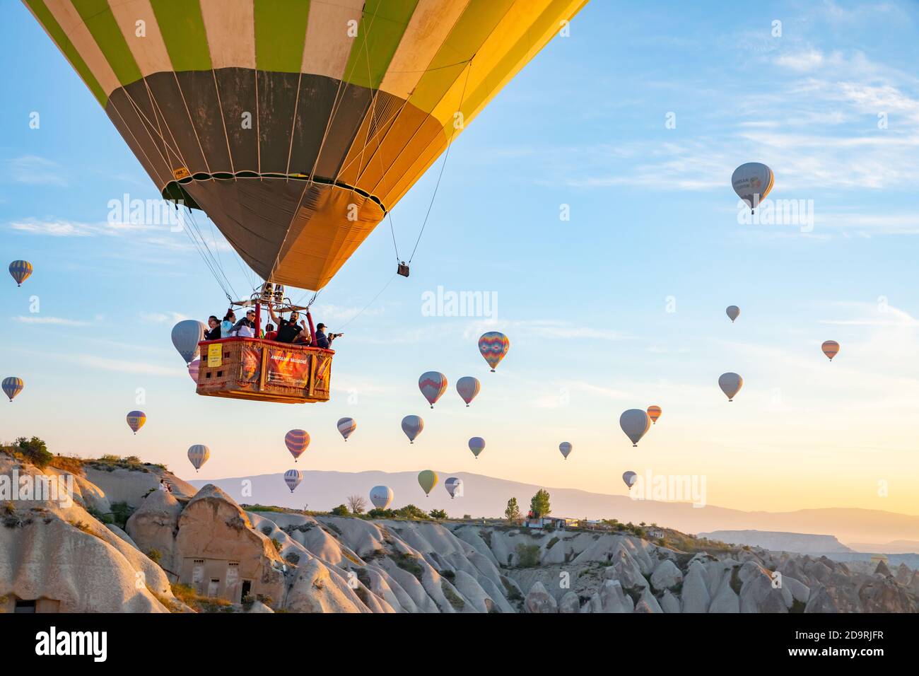 Hot Air balloons flying over Cappadocia valleys on sunrise Stock Photo ...