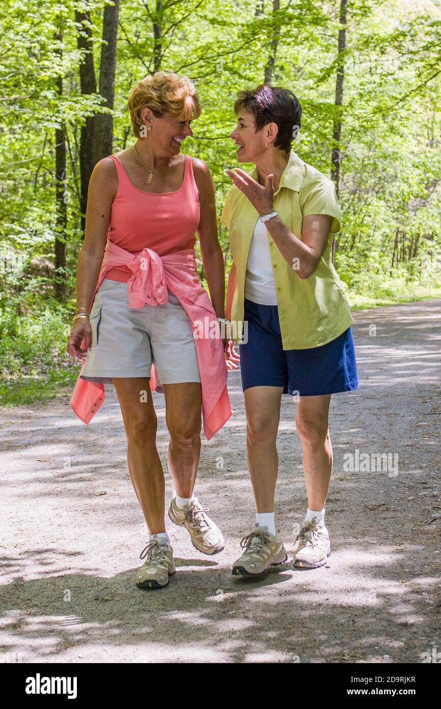 Two women talking as they are out for a walk Stock Photo