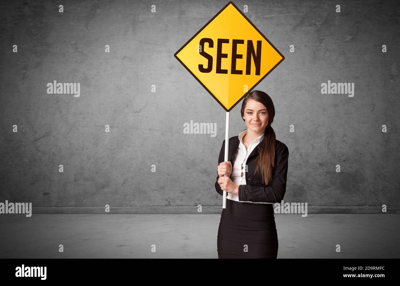 Seen. Sign Young business person holding road sign with SEEN inscription, new ...