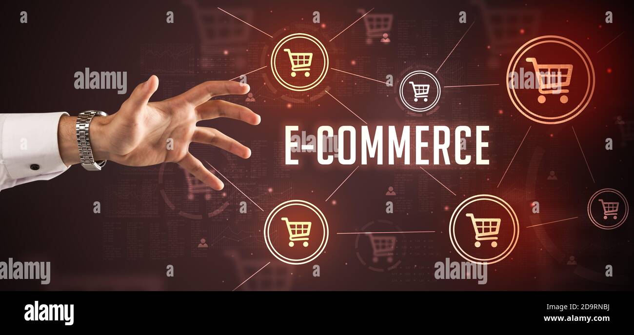 Close-Up of cropped hand pointing at E-COMMERCE inscription, online shopping concept Stock Photo