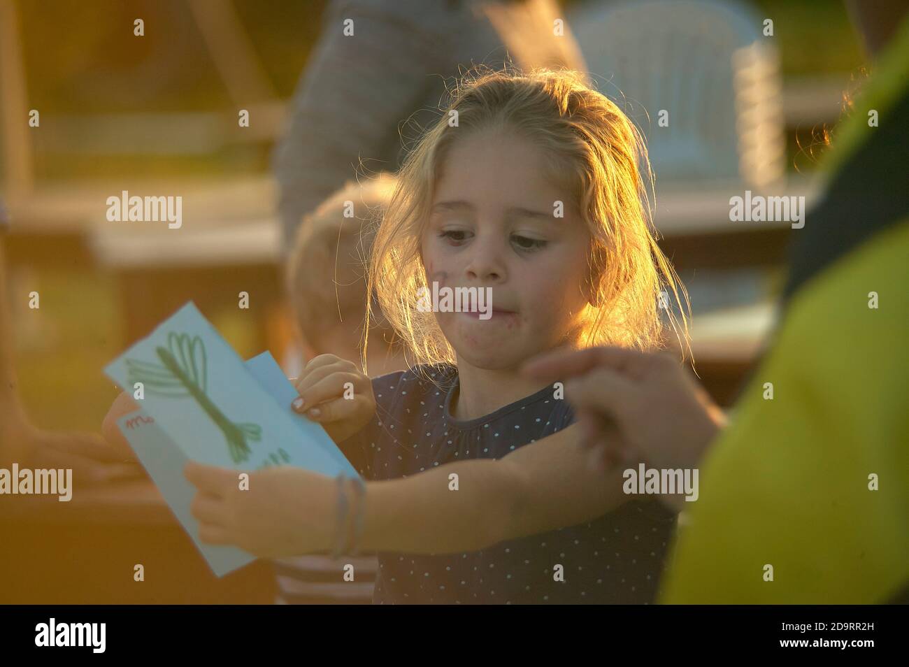 ROVIGO, ITALY 20 FEBRUARY 2020: Little girl shows drawing to mom Stock Photo