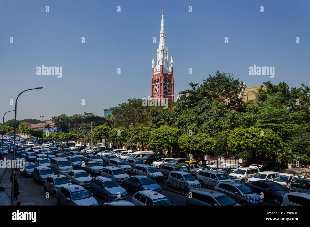 Traffic outside the Holy Trinity Anglican Church in Yangon, Myanmar Stock Photo