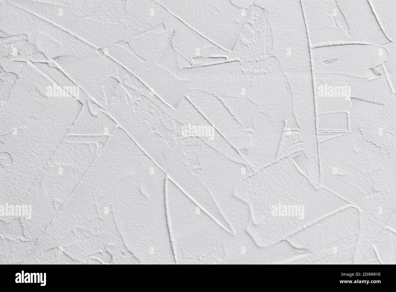 white textured background of filler paste applied with putty knife in irregular dashes and strokes Stock Photo