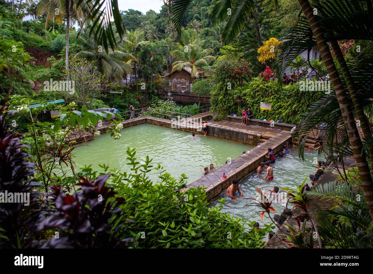 Banjar, Bali / Indonesia - March 08 2013: Locals and international visitors taking shower under famous sulphuric water in centuries-old Banjar Hot Stock Photo